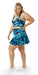 Full body side view of girl wearing blue animal print JH Butterfly Eco Skort with Pockets and matching bra putting one hand on waist