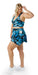 Full body side view of girl wearing blue animal print JH Butterfly Eco Skort with Pockets and matching bra brushing one side of her hair