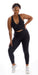 Full body front view of girl wearing black Midnight Eco Ultra High Waist Leggings and matching bra leaning on right leg and putting left hand on waist