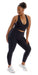 Full body front view of girl wearing black Midnight Eco Ultra High Waist Leggings and matching bra leaning on left bent knee