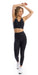 Full body front view of girl wearing black Midnight Eco Ultra High Waist Leggings and matching bra lifting both arms towards the top of her head