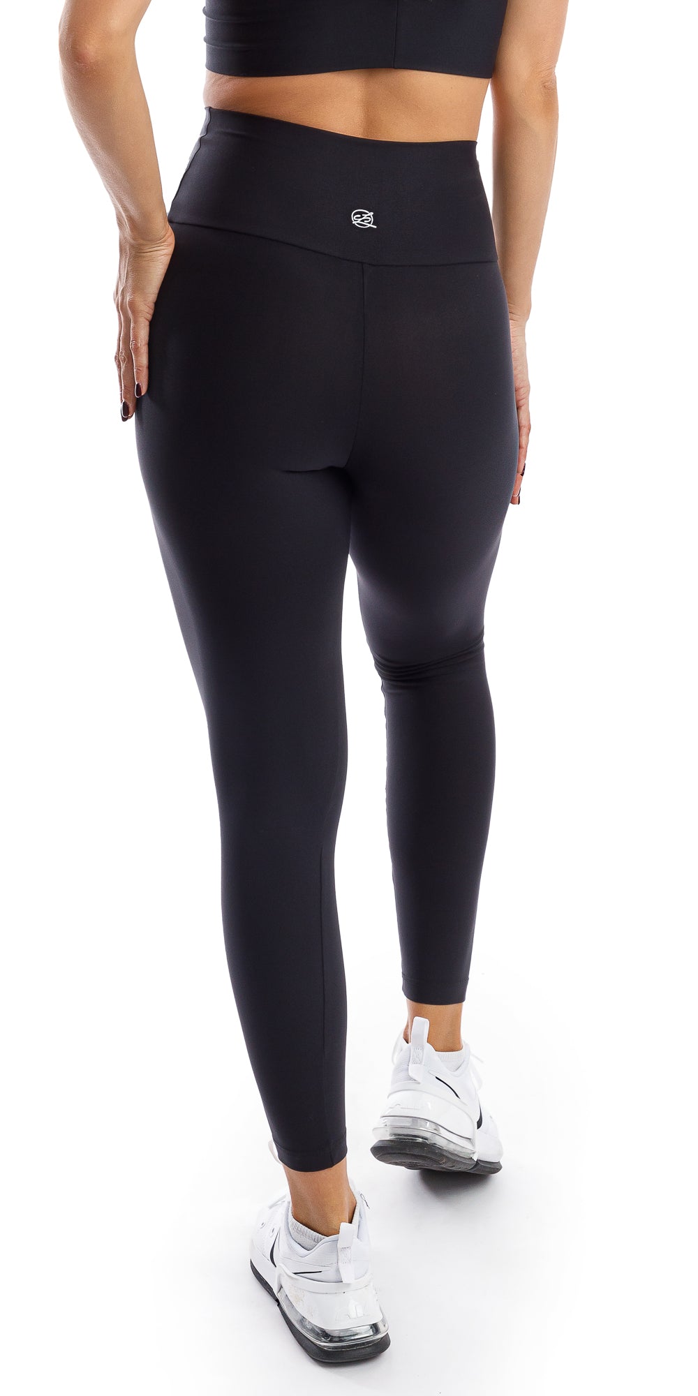 Back view of girl wearing black Midnight Eco Ultra High Waist Leggings putting one leg forward