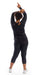 Full body rear view of girl wearing black Midnight Off The Shoulder Long Sleeve Tee and matching leggings lifting both arms towards the top of her head